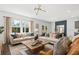 Bright and airy living room featuring large windows, contemporary furnishings, and stylish decor at 213 West Bradford Pointe Dr, Summerville, SC 29486