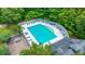 Aerial shot of a swimming pool and playground, surrounded by trees, creating a fun and recreational space at 215 Center Hill Ct, Summerville, SC 29485
