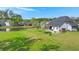 Spacious backyard featuring a pond, lush lawn, outdoor seating, and mature trees at 215 Center Hill Ct, Summerville, SC 29485