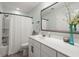 Well-lit bathroom with a white vanity, large mirror, shower with curtain, and modern fixtures at 215 Center Hill Ct, Summerville, SC 29485