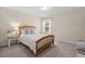 Bright bedroom featuring a wooden bed frame, white bedding, and a window with natural light at 215 Center Hill Ct, Summerville, SC 29485