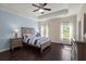 Comfortable bedroom featuring tray ceiling, hardwood floors, and natural light from windows at 215 Center Hill Ct, Summerville, SC 29485