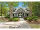 Charming clubhouse entrance framed by mature trees and manicured bushes, adding to the community's appeal at 215 Center Hill Ct, Summerville, SC 29485