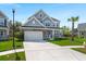 Beautiful two-story home with a well-maintained lawn, attached garage, and traditional design at 215 Center Hill Ct, Summerville, SC 29485