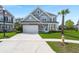 Classic two-story home with a manicured lawn, attached garage, and traditional architectural details at 215 Center Hill Ct, Summerville, SC 29485