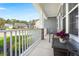 Charming front porch featuring stone pillars, white railings, and a cozy seating area at 215 Center Hill Ct, Summerville, SC 29485