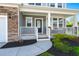 Inviting front porch with stone accents, white railings, and lush landscaping at 215 Center Hill Ct, Summerville, SC 29485