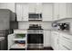 Stylish kitchen features white cabinets and stainless steel appliances at 215 Center Hill Ct, Summerville, SC 29485