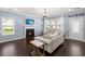 Cozy living room features a fireplace, large windows, and comfortable seating at 215 Center Hill Ct, Summerville, SC 29485