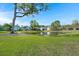 Scenic view of a pond surrounded by well-maintained lawns and neighborhood homes on a clear, sunny day at 215 Center Hill Ct, Summerville, SC 29485
