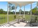 Relaxing screened porch with chairs, offering views of the landscaped backyard and green space at 215 Center Hill Ct, Summerville, SC 29485