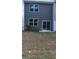 The house's backyard has sliding glass doors that let in natural light at 2402 Scarlett Maple St, Summerville, SC 29486