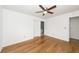 Bedroom with hardwood floors and a ceiling fan, adjacent to ensuite bathroom at 2441 Hansard Dr, North Charleston, SC 29406