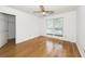 Bright bedroom features hardwood flooring, a ceiling fan, and a window with natural light at 2441 Hansard Dr, North Charleston, SC 29406