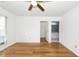 Bedroom with a window, hardwood floors, and a ceiling fan, leading into the ensuite bathroom at 2441 Hansard Dr, North Charleston, SC 29406
