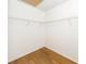 Walk-in closet with simple shelving and wood flooring at 2441 Hansard Dr, North Charleston, SC 29406