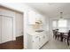 Bright kitchen with white cabinets and appliances, connecting seamlessly to the dining area at 2441 Hansard Dr, North Charleston, SC 29406