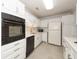 Well-lit kitchen with white cabinetry, black appliances, and a functional layout for cooking at 2441 Hansard Dr, North Charleston, SC 29406