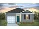 Charming single-story home with gray siding, attached garage, and well-manicured lawn at 257 Wild Strawberry Ln, Moncks Corner, SC 29461