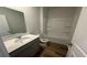 Bathroom featuring a gray vanity, sink, mirror and bathtub with a shower at 260 Wild Strawberry Ln, Moncks Corner, SC 29461