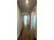 Long hallway with wood-look floors, connecting various rooms and spaces within the home at 260 Wild Strawberry Ln, Moncks Corner, SC 29461