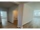 Hallway view with wood flooring leading to multiple rooms and a laundry room at 260 Wild Strawberry Ln, Moncks Corner, SC 29461