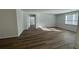 Bright living room with wood flooring and plenty of natural light from the large window at 260 Wild Strawberry Ln, Moncks Corner, SC 29461