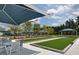 Bocce ball court area shaded by umbrellas and surrounded by beautiful landscaping at 267 Garden Gate Way, Summerville, SC 29486