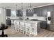 Modern kitchen with gray cabinets, stainless steel appliances, and an island with seating and pendant lighting at 267 Garden Gate Way, Summerville, SC 29486