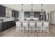 Modern kitchen with gray cabinets, stainless steel appliances, and an island with seating and pendant lighting at 267 Garden Gate Way, Summerville, SC 29486