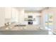 Modern kitchen featuring white cabinets, granite countertops, stainless steel appliances, and a sliding door at 267 Wild Strawberry Ln, Moncks Corner, SC 29461