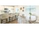 Bright kitchen with white cabinets, granite countertops, stainless steel appliances, and a dining area with wood floors at 267 Wild Strawberry Ln, Moncks Corner, SC 29461
