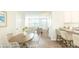 Open concept living area with dining table, bar seating, and a view into a bright and airy living room at 267 Wild Strawberry Ln, Moncks Corner, SC 29461