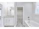 Modern bathroom featuring a granite vanity, walk-in closet, and a separate tub at 277 W Smith St, Lincolnville, SC 29485