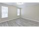 A bright bedroom features large windows and light-colored wood flooring at 277 W Smith St, Lincolnville, SC 29485