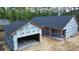 Exterior view of new home construction shows a detached garage connected by a covered walkway at 277 W Smith St, Lincolnville, SC 29485