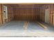 Interior of garage shows concrete floor and exposed framing with door to outside at 277 W Smith St, Lincolnville, SC 29485