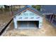 View shows a large garage with open door, ready to store cars and outdoor equipment at 277 W Smith St, Lincolnville, SC 29485