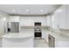 A bright kitchen features white cabinets, stainless steel appliances, granite countertops, and light-colored wood flooring at 277 W Smith St, Lincolnville, SC 29485