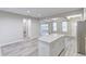 Modern kitchen with white cabinets, granite countertops, stainless appliances and light-colored wood flooring at 277 W Smith St, Lincolnville, SC 29485