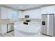 Bright kitchen features white cabinets, stainless steel appliances, granite countertops, and kitchen island at 277 W Smith St, Lincolnville, SC 29485