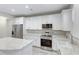 Modern kitchen with white cabinets, stainless steel appliances, granite countertops and light-colored wood flooring at 277 W Smith St, Lincolnville, SC 29485