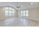 Bright living room with vaulted ceilings, expansive windows, and modern flooring for an airy feel at 277 W Smith St, Lincolnville, SC 29485