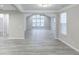 Spacious living room with vaulted ceiling, lots of windows, and modern flooring at 277 W Smith St, Lincolnville, SC 29485