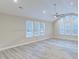 Open concept living room features hardwood flooring and lots of natural light from large windows at 277 W Smith St, Lincolnville, SC 29485