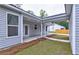Covered patio with gray siding and white trim, perfect for outdoor relaxation and entertaining at 277 W Smith St, Lincolnville, SC 29485