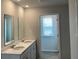 Bathroom featuring double sinks and a window at 283 Blue Haw Dr, Moncks Corner, SC 29461