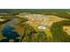 Expansive aerial view of a new residential community featuring lush green spaces and a tranquil lake at 297 Blue Haw Dr, Moncks Corner, SC 29461