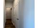 Hallway with wood-look floors and white doors leading to various rooms at 297 Blue Haw Dr, Moncks Corner, SC 29461