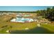 Community pool with a splash pad, pergola, playground, and a view of new homes in the neighborhood at 297 Blue Haw Dr, Moncks Corner, SC 29461